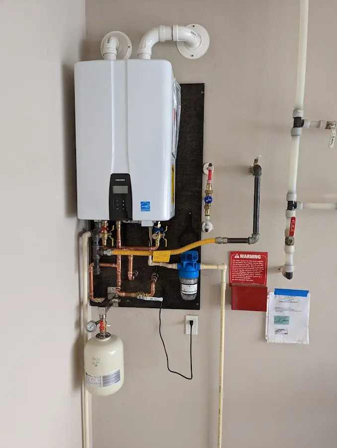 Professional plumber installing copper piping in a Trenton home